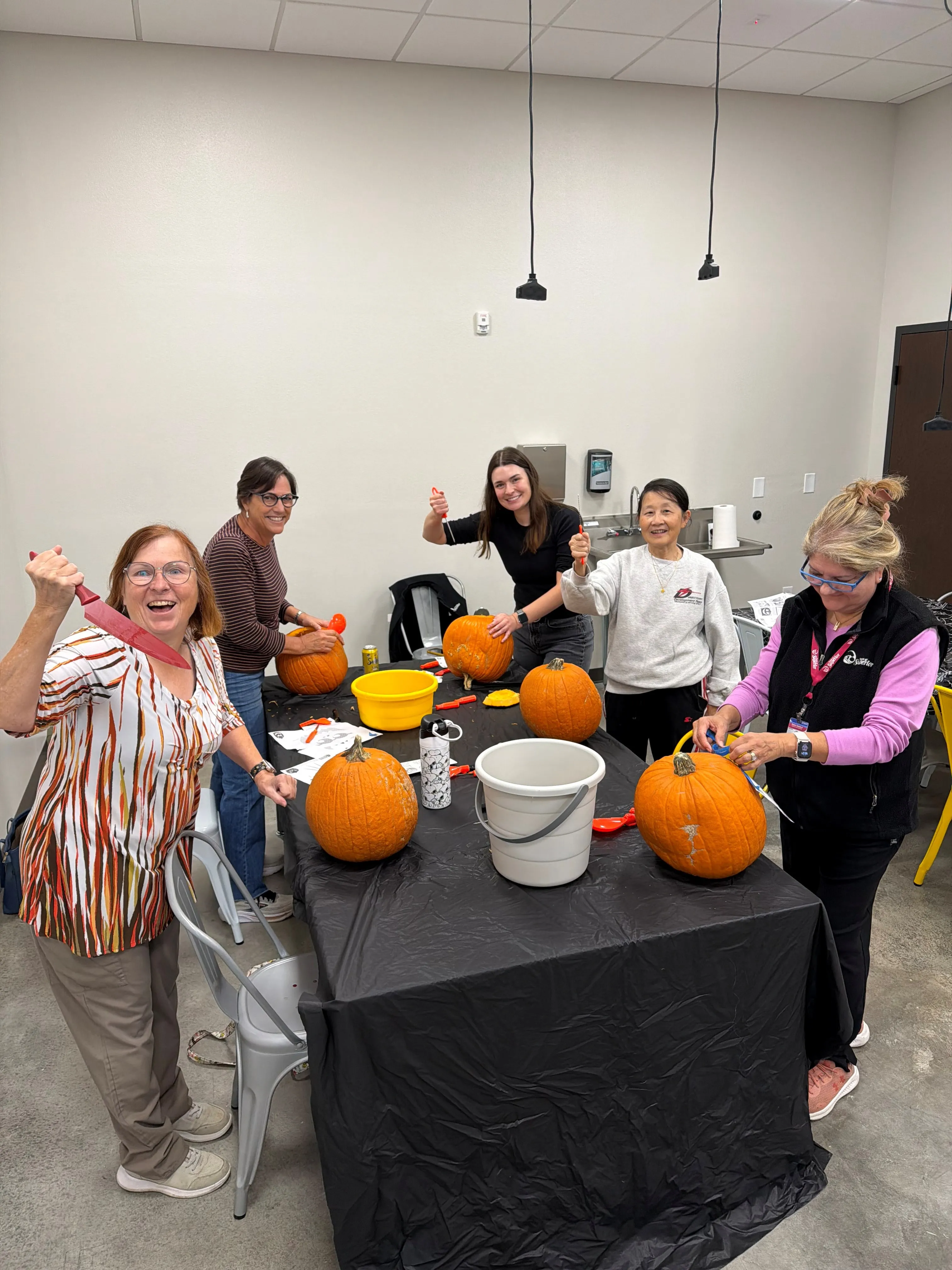 Vargas employees carving pumpkins